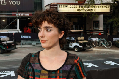 A Memphian with short curly hair stands outside a venue, framed by a "SXSW 2026 Film & TV Festival Obsession" marquee sign in the background.