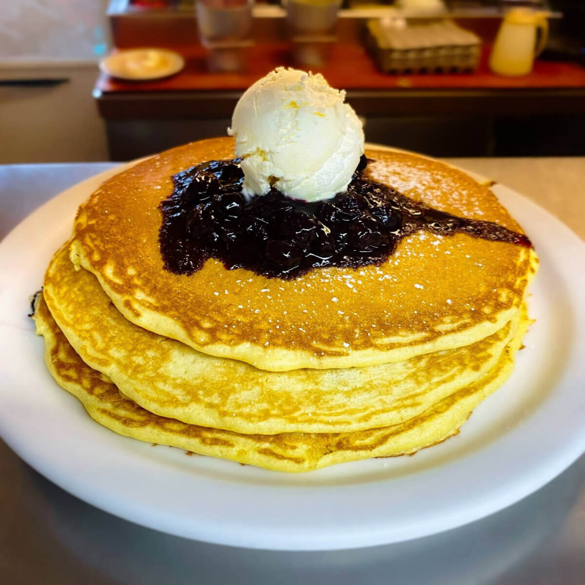 Midwest Weekend Getaway: My Mackinac Island Escape - 12 A stack of three pancakes topped with blueberries and butter.