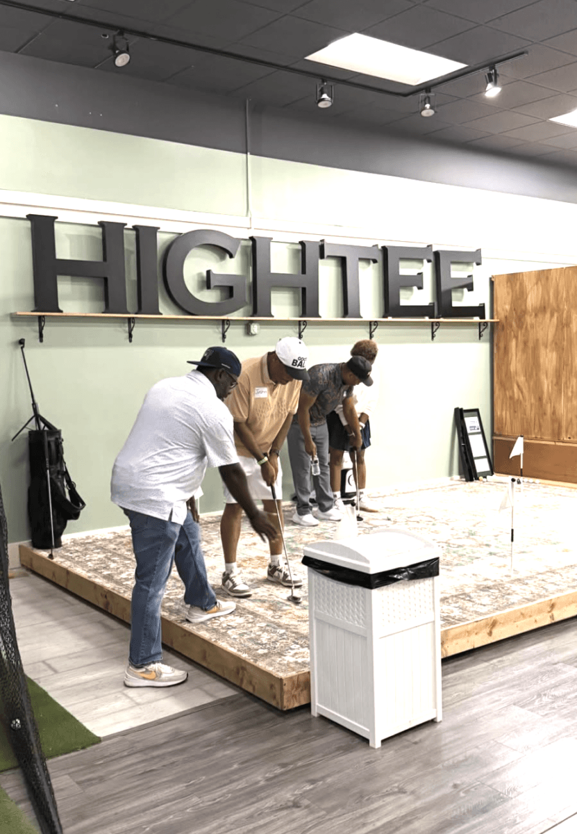 It's Playtime, Memphis! Here's Where to Get Your Game On - 2 Four people practice putting on an indoor golf green under a large “HIGHTEE” sign. Golf clubs, a bench, and a white air purifier are visible in the scene.