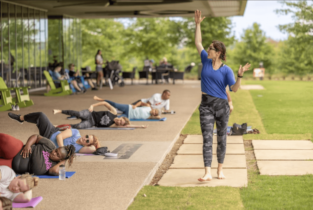 How to Meet New People in Memphis: 19 Cool Clubs for Grown-Ups - 4 A woman teaches an exercise class outdoors.