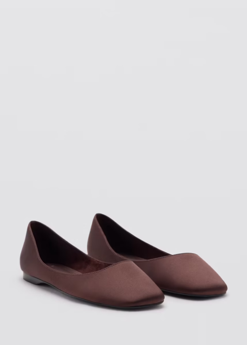 A pair of brown pointed-toe flats with a matte finish, perfect for fall fashion and ready to wear, displayed on a plain light gray background.