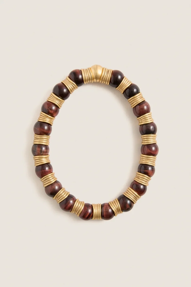 Brown beaded bracelet with gold-tone metal spacers arranged in an alternating pattern, displayed on a plain light background.
