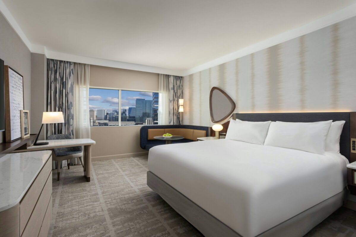 A bed in a hotel room with modern design.