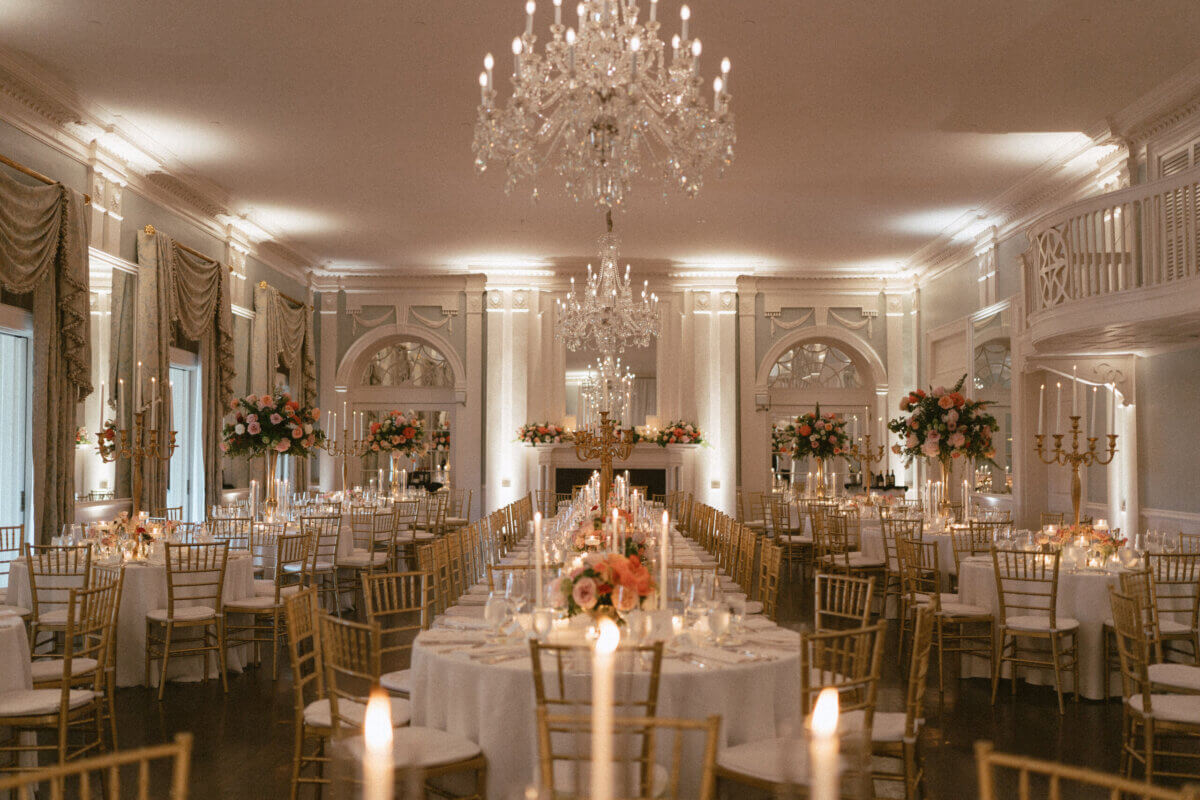 A Country Club Wedding with Show-Stopping Bridal Fashion & Peonies for Days - 19 Elegant banquet hall with chandeliers, round tables set for a formal event, gold chairs, floral centerpieces, and soft ambient lighting—the perfect setting for a classic wedding at Belle Meade Country Club or an unforgettable Nashville wedding celebration.