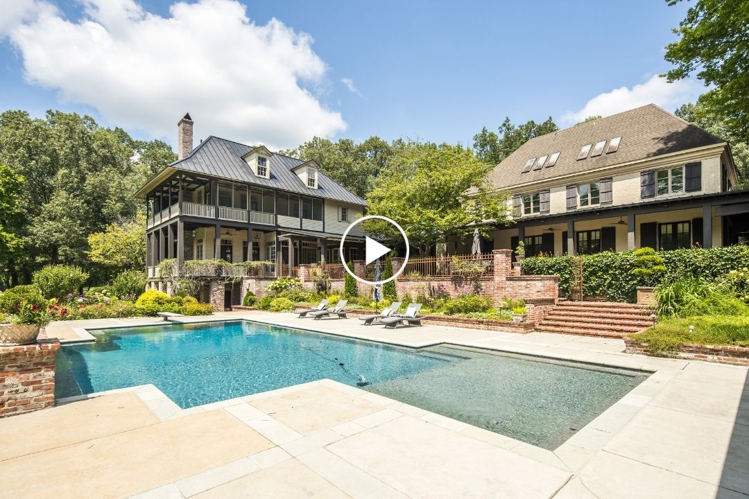 Large house with a covered porch, surrounded by trees in Unincorporated TN, features a spacious backyard with a rectangular swimming pool, lounge chairs, and brick steps leading to a garden area at 8891 Forest Meadow Dr.