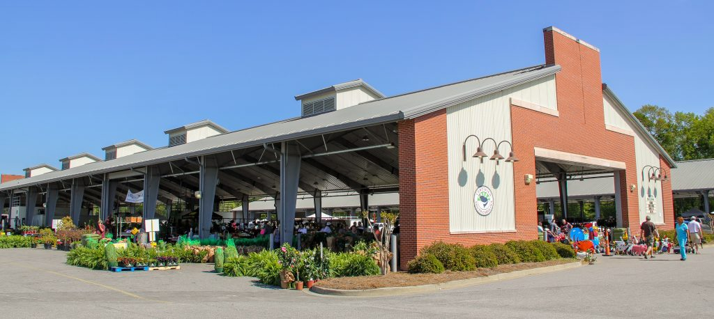 5 Destinations Where Southern Charm Thrives - 3 Open-air farmers market pavilion with a brick and metal exterior radiates Southern charm.