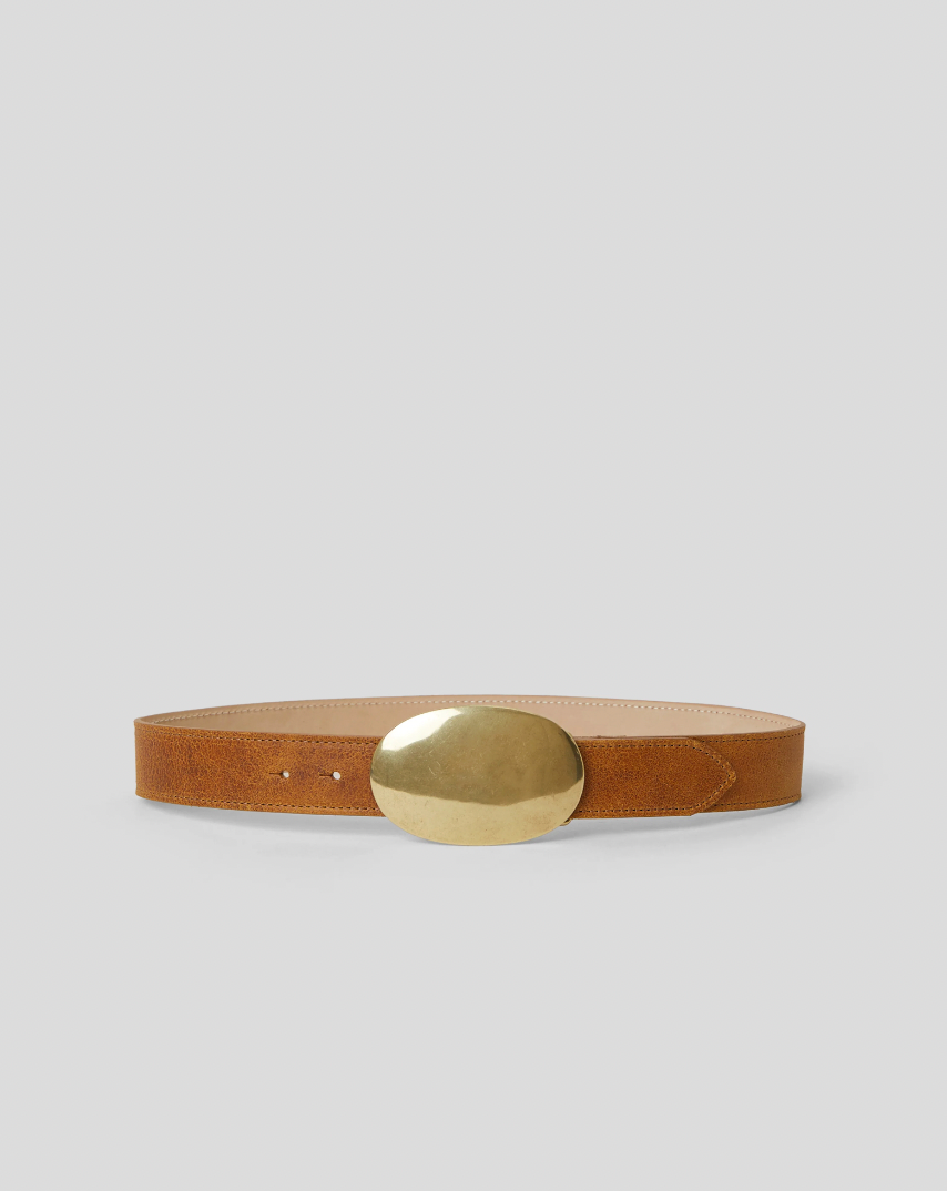 Brown leather belt with a large, round gold buckle displayed against a plain light gray background.