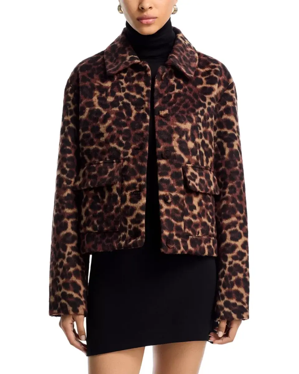 Fall Is Getting Wild: Animal Prints Are Back! - 8 A woman wearing a cropped leopard print jacket—an iconic nod to animal prints—over a black turtleneck top and a black skirt, shown from the shoulders down, embodies effortlessly chic fall fashion.