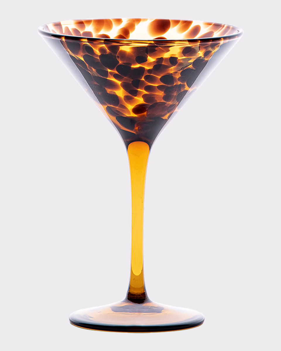 Fall Is Getting Wild: Animal Prints Are Back! - 29 A martini glass with a tortoiseshell pattern in shades of amber and brown, inspired by animal print trends, set against a plain light gray background.