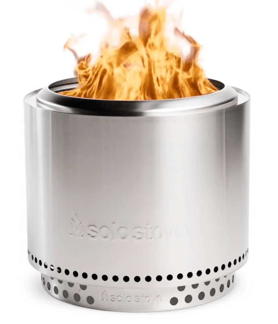 A stainless steel Solo Stove fire pit with visible flames emerging from the top, set against a plain white background, makes a perfect addition to your fall decor.