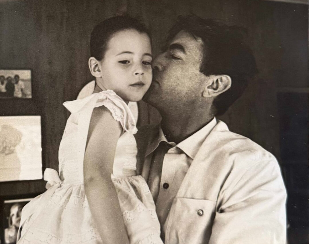 Gregory Peck kisses his young daughter, Cecilia Peck, on the cheek.