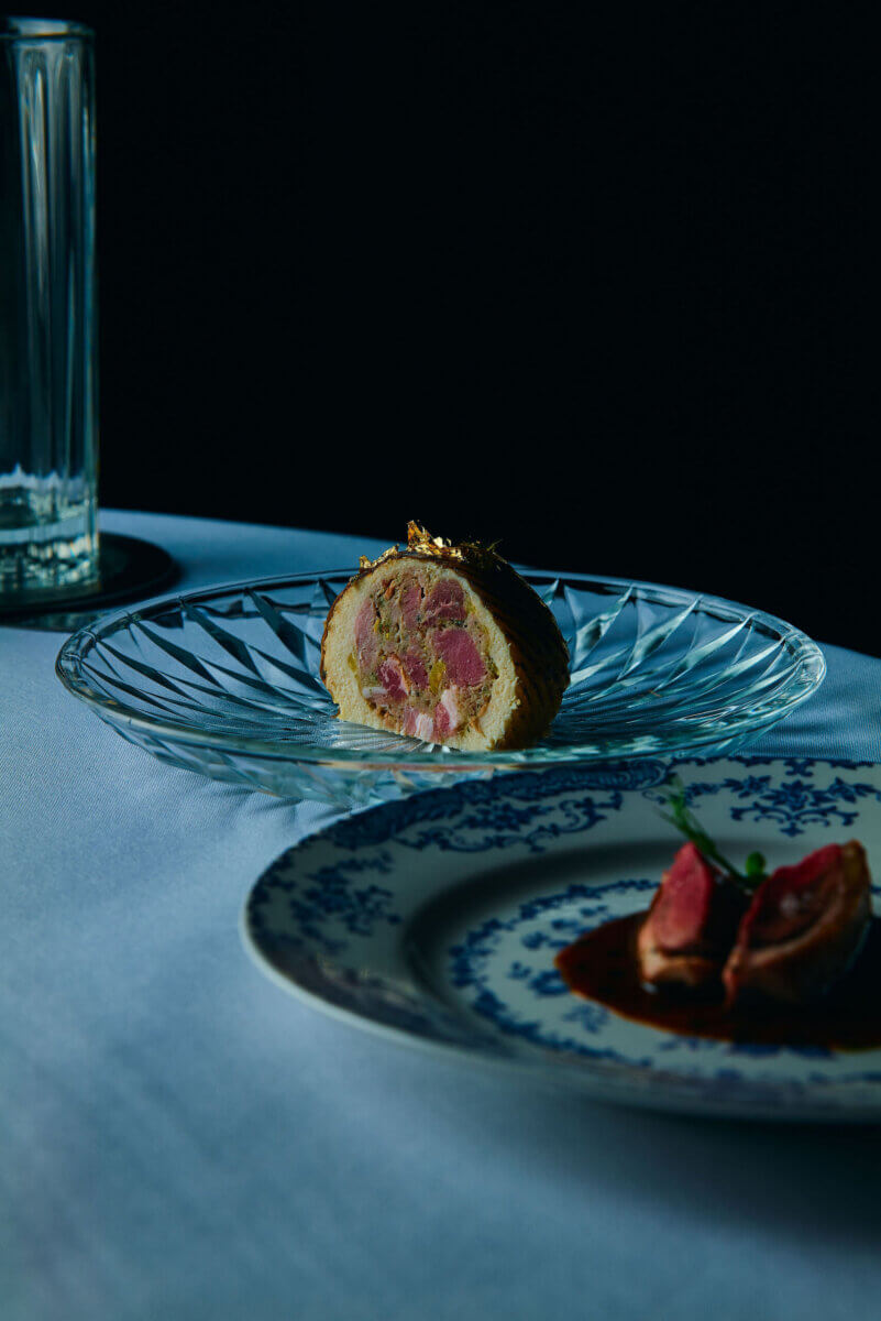 A sliced roulade sits on a clear glass plate, atop a white tablecloth—an inviting scene that captures the spirit of Birmingham, where you can truly eat your way around the world.