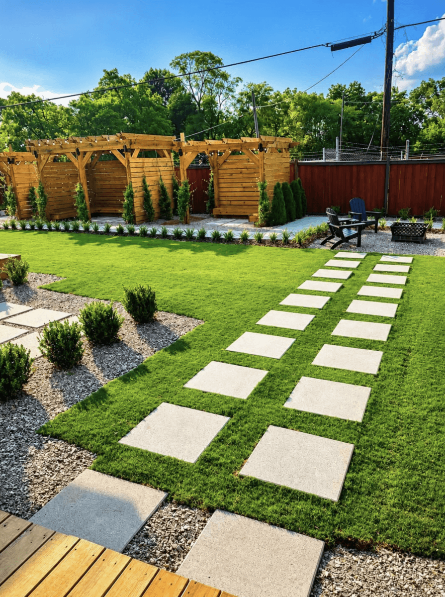 A backyard with a green lawn, square stone path, wooden pergola, small shrubs, and two chairs around a fire pit—perfect for relaxing after exploring the best places to eat at Birmingham restaurants.