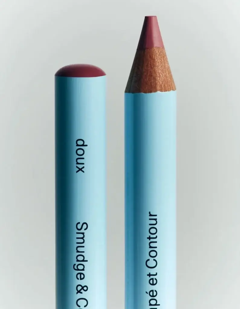 17 Fall-Ready Nashville FINDS: Cozy Layers, Beauty & Spooky Season Style - 7 Two blue makeup pencils stand upright; one is capped, the other sharpened. Both feature black vertical text—perfect for your Nashville finds this October.