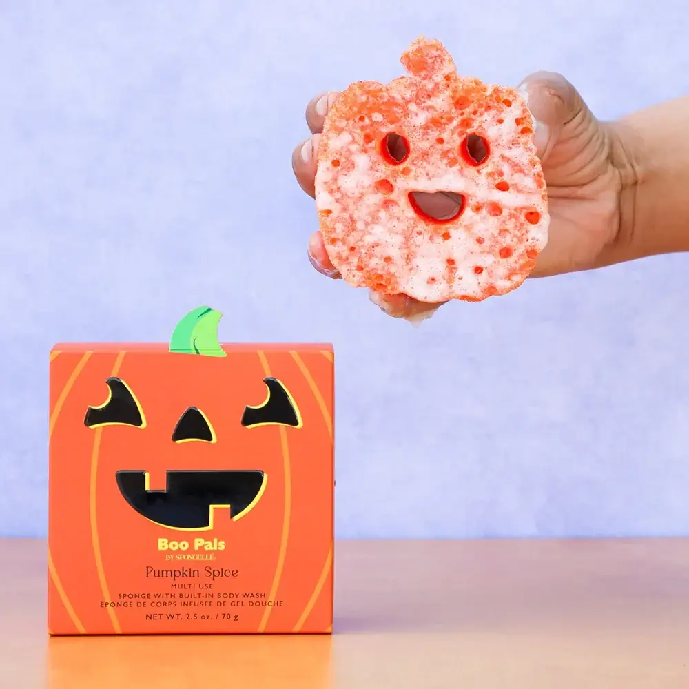 17 Fall-Ready Nashville FINDS: Cozy Layers, Beauty & Spooky Season Style - 8 A hand holds a pumpkin-shaped orange sponge with a smiling face, a perfect Nashville find for October, next to a pumpkin-themed box labeled “Boo Pals Pumpkin Spice.”.