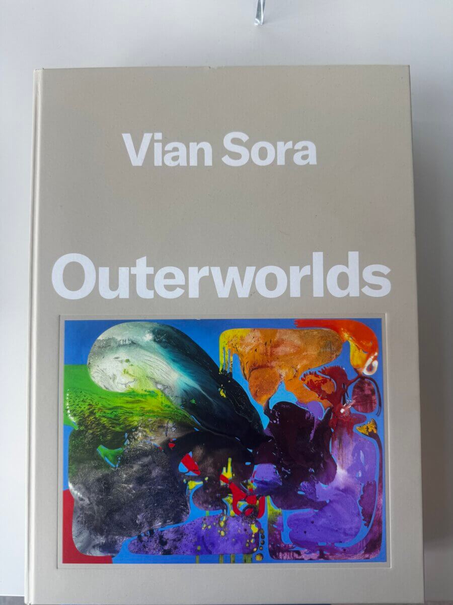 17 Louisville FINDS for October: Fall Fashion, Festive Decor & Game-Day Essentials - 12 A beige book cover titled “Vian Sora Outerworlds” with a colorful abstract artwork in green, yellow, red, purple, and blue at the bottom, inspired by Louisville’s vibrant art scene and perfect for October FINDS.