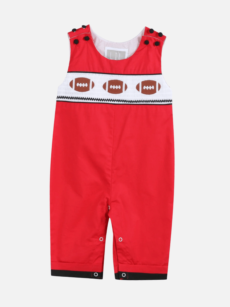 17 Louisville FINDS for October: Fall Fashion, Festive Decor & Game-Day Essentials - 18 Red baby romper with black buttons on the shoulders and a white chest panel featuring a row of brown football designs—perfect for cozy finds in Louisville this October.