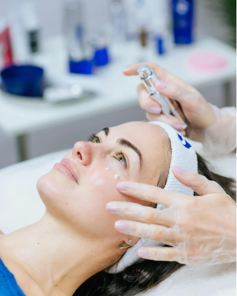 Nashville Steals, Deals & Announcements: October 2026 - 2 A person receives a facial treatment as a gloved professional uses a tool near their eye while they lie on a treatment bed, taking advantage of exclusive Nashville deals this October 2026.
