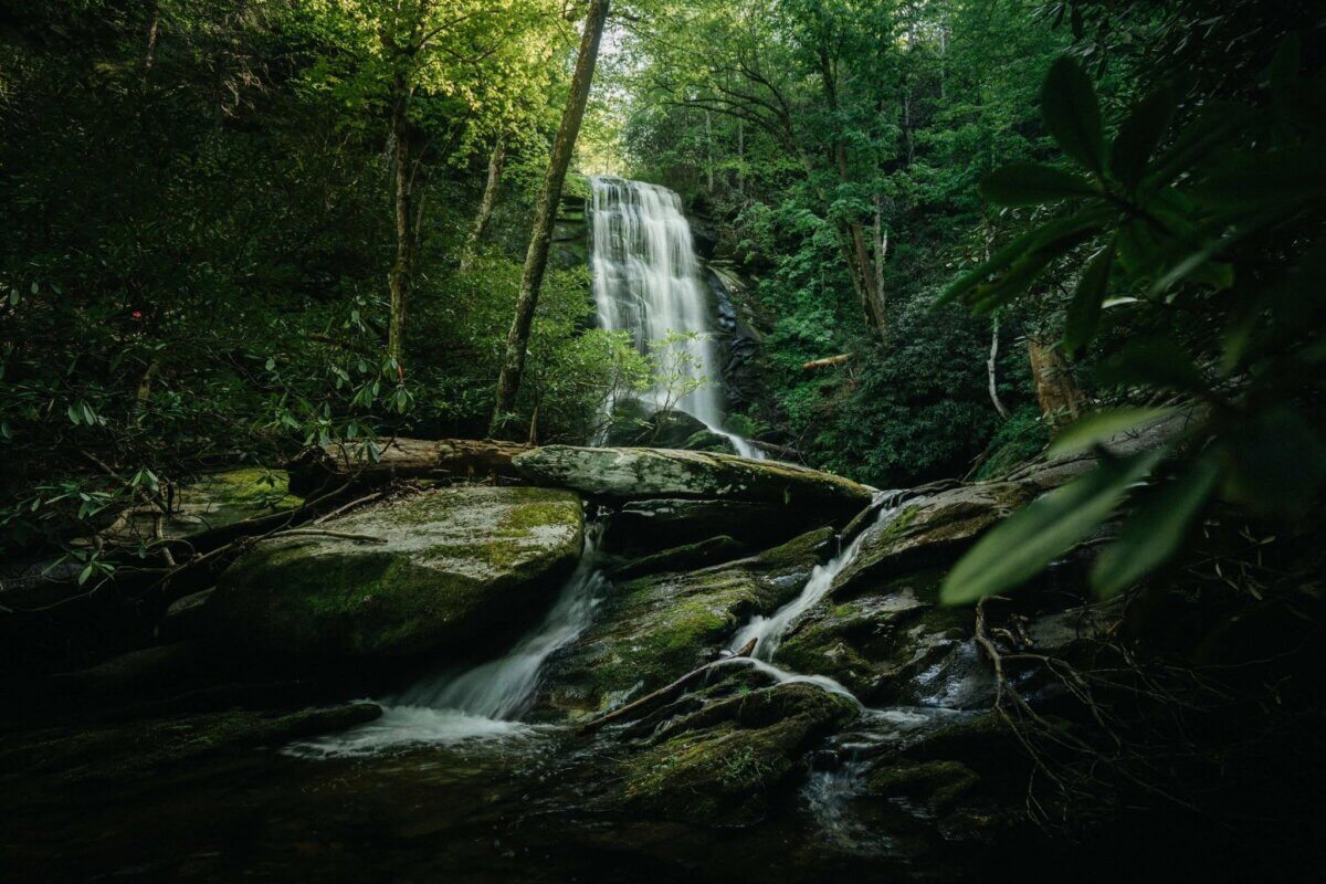 5 NEW Hikes to Explore Around the South - 7 The Catawba Falls cascade over rocks into a stream near Old Fort in North Carolina.