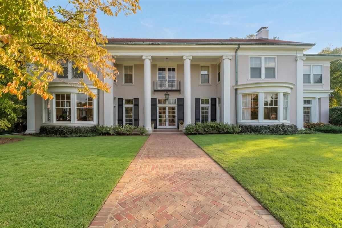 A large, two-story house at 1857 Overton Park Avenue with white columns and a brick walkway leading to the front entrance.
