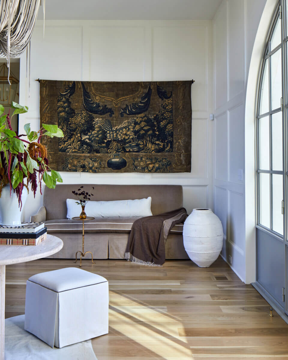 Your Home Should Tell Your Story — and Leigh Misso Wants to Help You Write It - 4 A River Brook Design and Construction room featuring a beige sofa, a large wall tapestry, and a white floor vase.