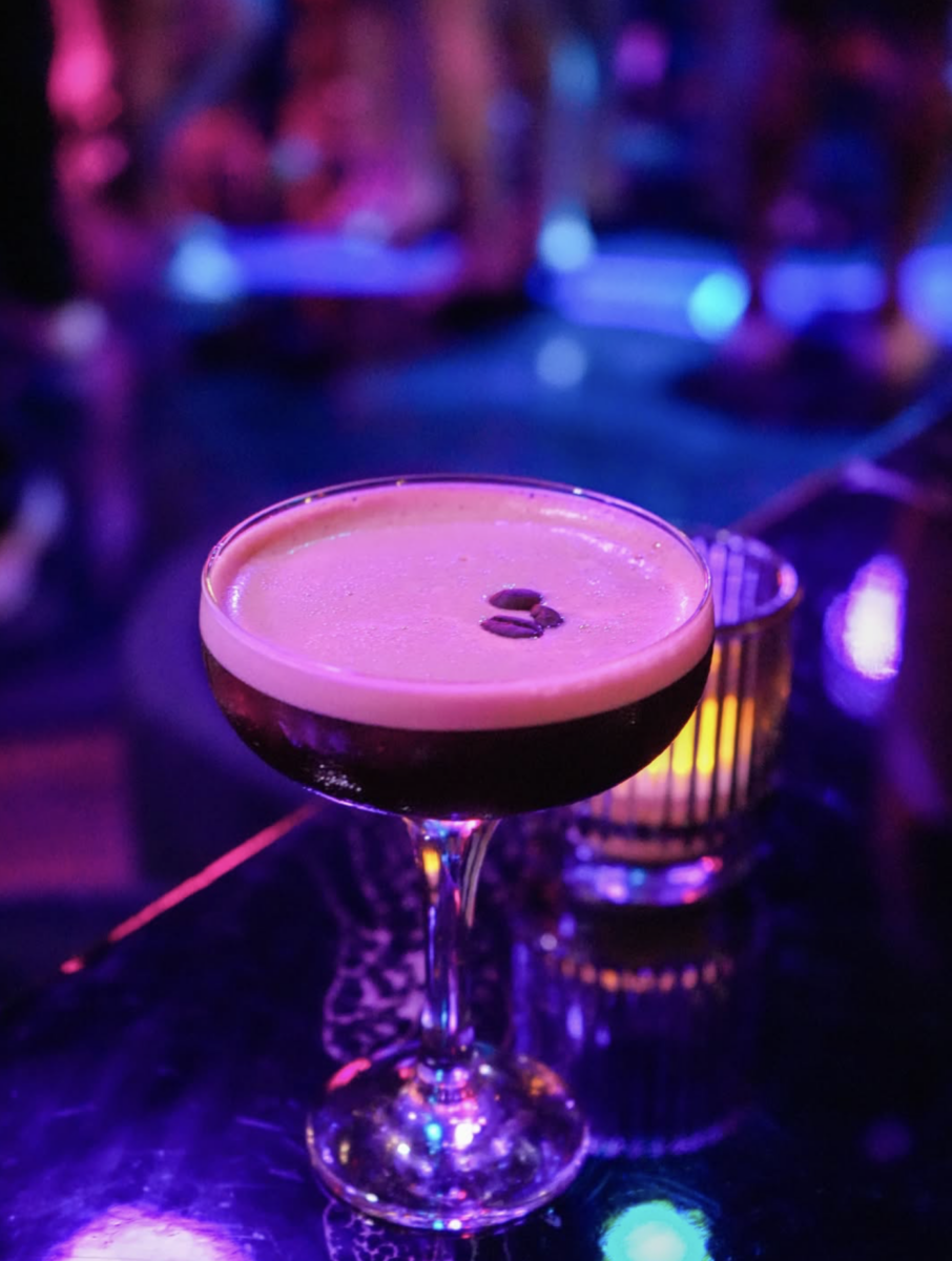 5 New Birmingham Restaurants to Try This Month (Plus An Expansion & A Relocation!) - 5 Espresso martini in a coupe glass garnished with three coffee beans, sitting on a dark table in a dimly lit bar.