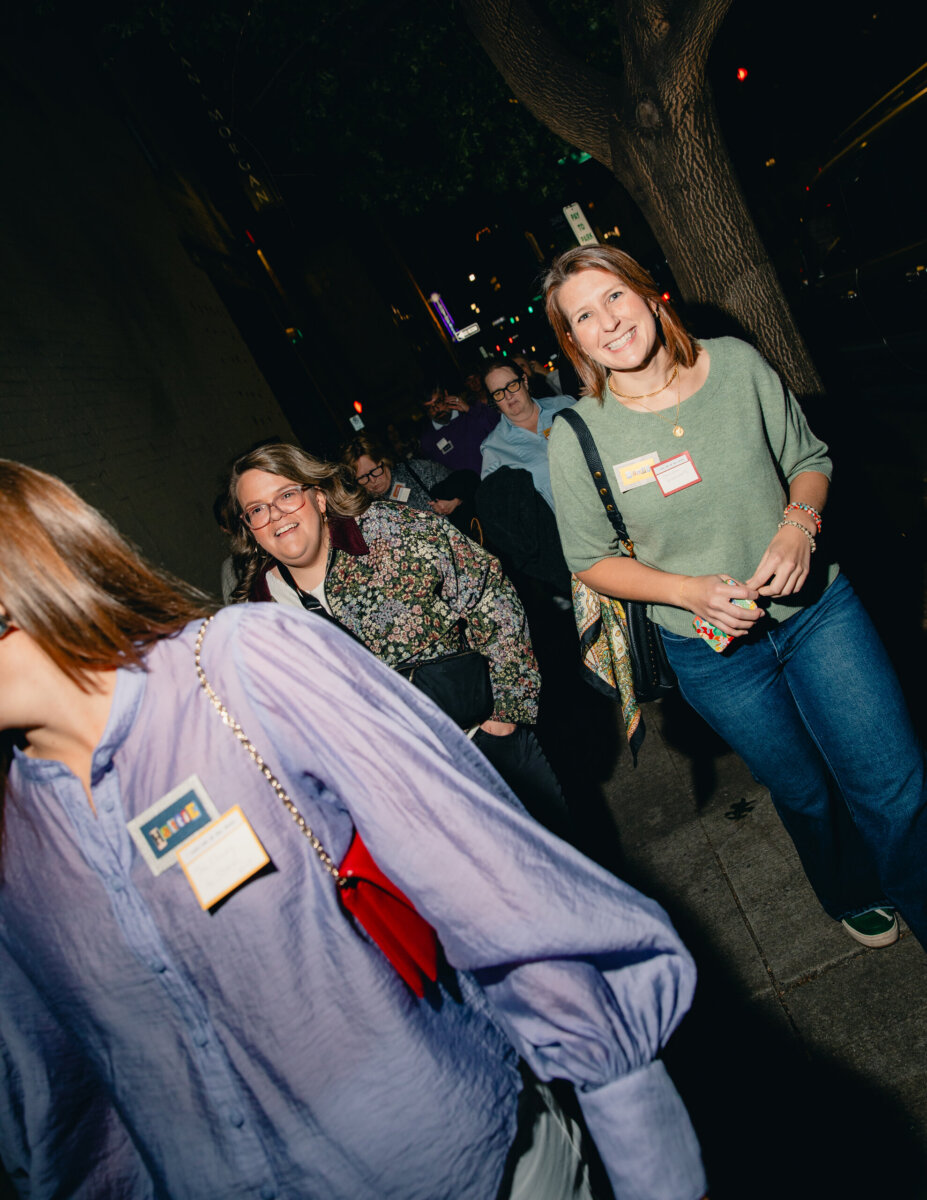 What Happens When You Bring 22 Birmingham Strangers Together and Say "Trust Me"? - 8 A group of people wearing Trust Me Night name tags walking down a Birmingham city sidewalk at night.