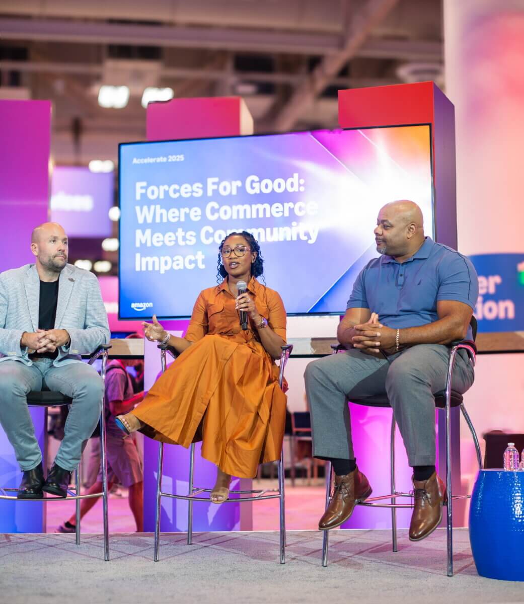 She Started Roasting Coffee on Her Stovetop. Now Target & Amazon Are Calling. - 6 Three people sit on stage in discussion at an event with a screen behind them displaying “Forces For Good: Where Commerce Meets Community Impact.”.