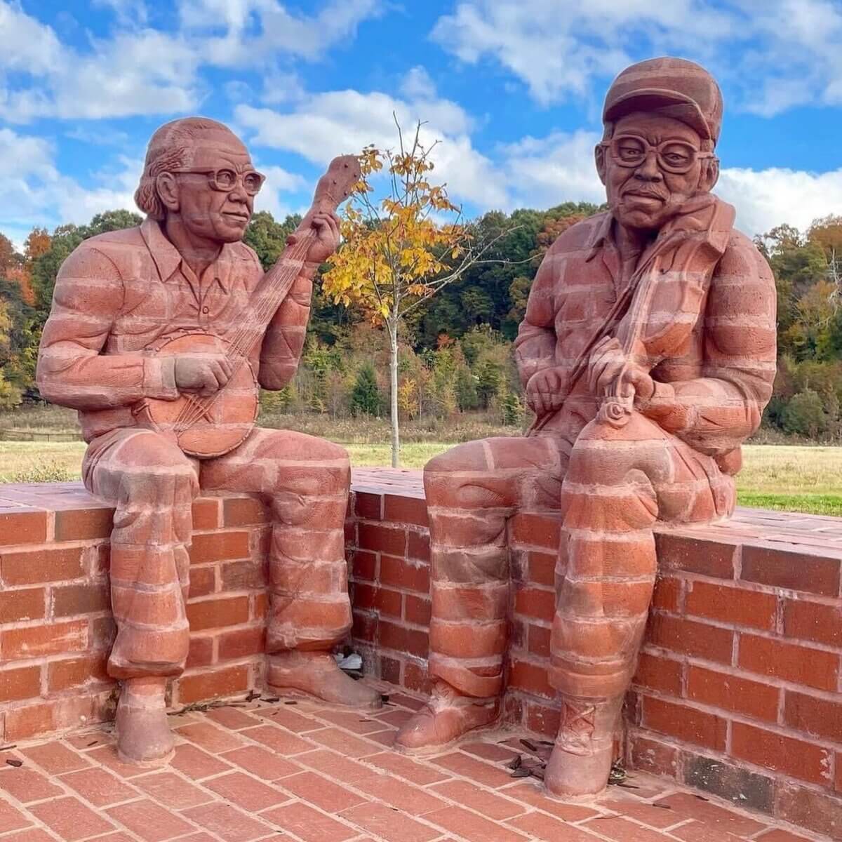 Our Favorite Historic Downtowns in the South to Explore - 4 Brick statues of two men playing instruments.