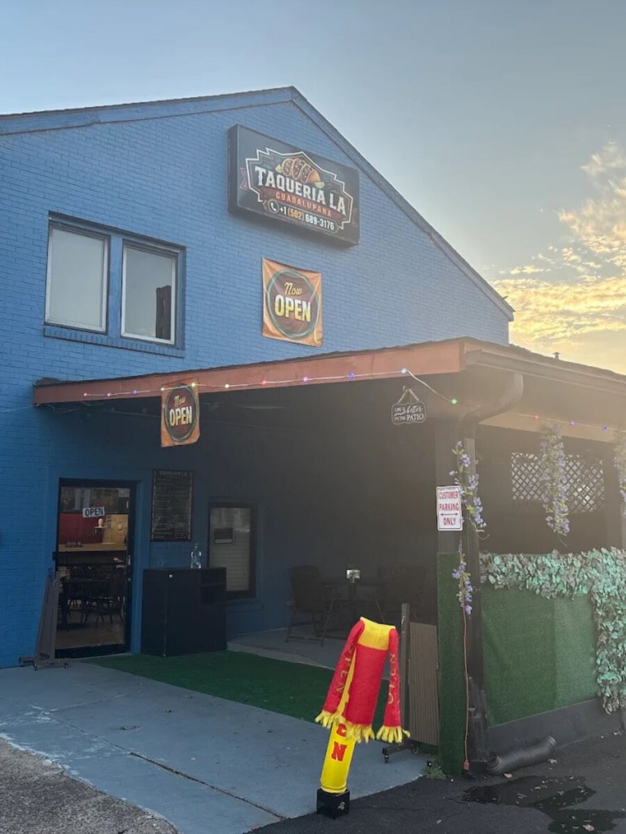 Taqueria La Guadalupana restaurant, a standout among Louisville restaurants, featuring a blue exterior and an outdoor patio.