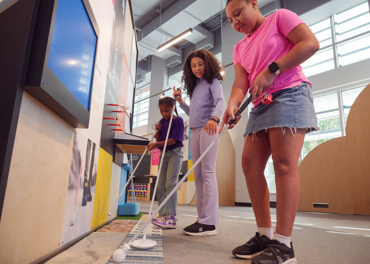 Stevie Wonder's Piano, Helen Keller's Desk & the Louisville Museum Where Every Guest Gets to Touch History - 5 Three girls use white canes to navigate a tactile path at The Dot Experience.