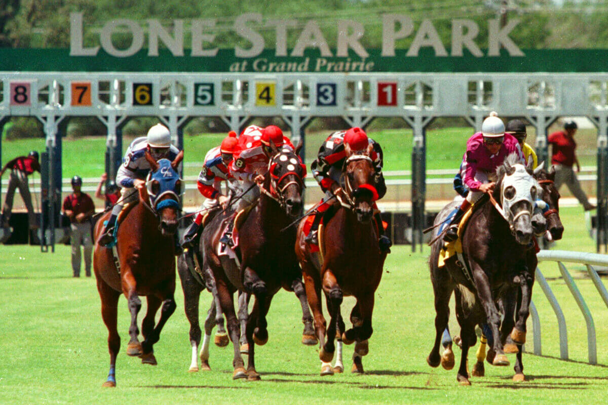 8 Lesser-Known Southern Horse Racing Venues to Know (and When to Go!) - 2 Jockeys riding horses in a race at Lone Star Park.