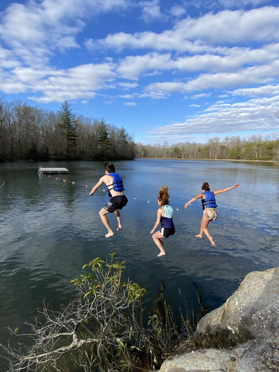 5 Reasons This Idyllic TN Private School Might Be Right for Your Family - 4 Three kids jump into a lake.