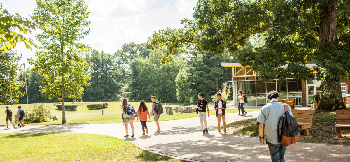 5 Reasons This Idyllic TN Private School Might Be Right for Your Family - 6 A group of college prep high school students walking along a paved path on a sunny university campus.
