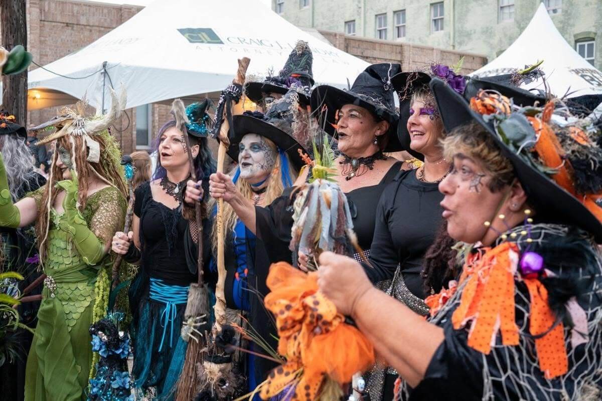 7 Spooky Southern Legends That'll Make You Lock Your Door Tonight - 3 A group of people in spooky folklore-inspired witch costumes and hats outdoors.