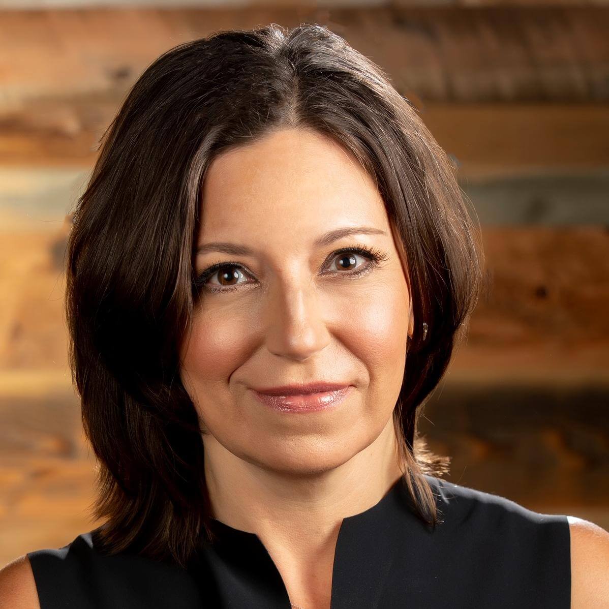 Headshot of Sally Williams with dark hair wearing a black sleeveless top.