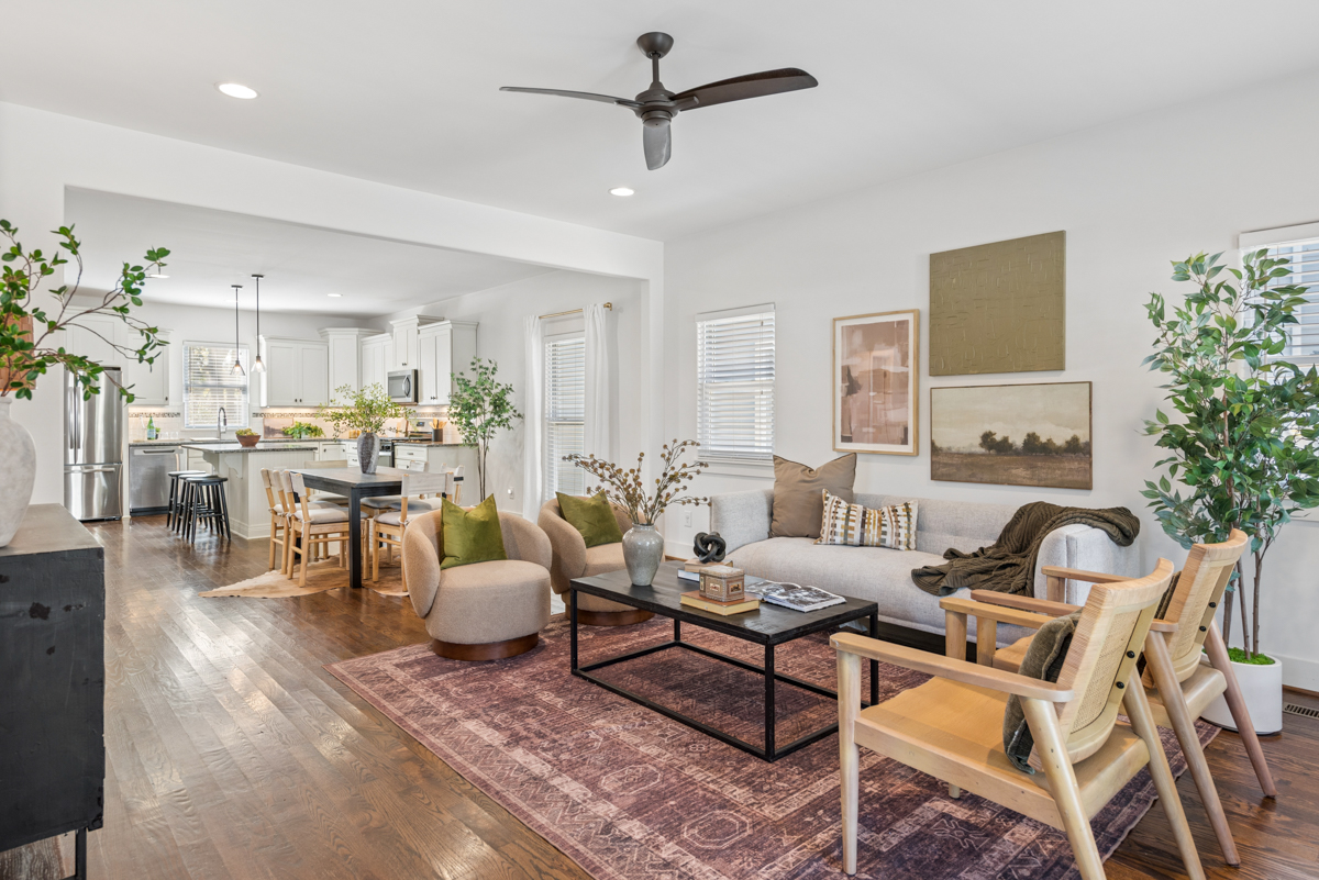 Open-concept living room and dining area at 6363 Columbia Ave, Nashville, featuring a sofa, two armchairs, a coffee table, and a dining table with chairs.
